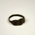 Ancient silver jewelry with three connected oval forms and visible age-related surface wear