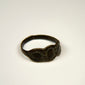 Ancient silver jewelry with three connected oval forms and visible age-related surface wear