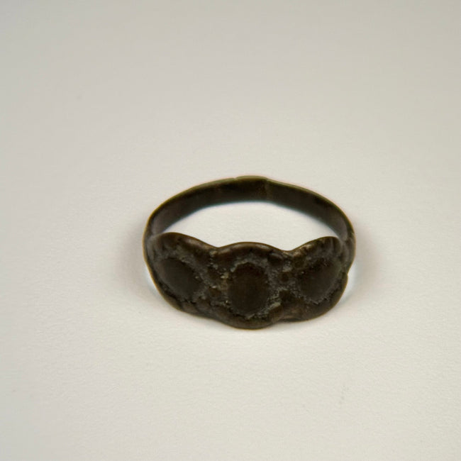 Ancient silver ring with intact band, textured patina, and prominent three-part oval bezel