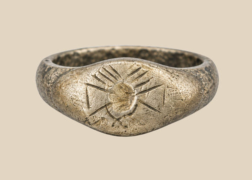 Ancient silver signet ring with finely engraved sunburst motif on bezel, thin rounded band, and natural aged patina, dating to the Late Roman to Early Byzantine period, circa 200–500 CE.