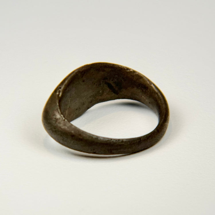Ancient Eastern Mediterranean silver ring with engraved sunburst symbol and rounded band