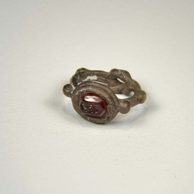 Early Byzantine silver and garnet ring showing the engraved intaglio set within a raised circular bezel