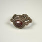 Close-up of Late Roman silver intaglio ring highlighting the engraved garnet and decorative bezel setting