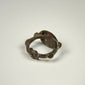 Reverse angle of ancient silver and garnet ring displaying the historic band construction and natural surface wear