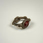 Ancient garnet intaglio signet ring with decorative silver shoulders and preserved dark red gemstone