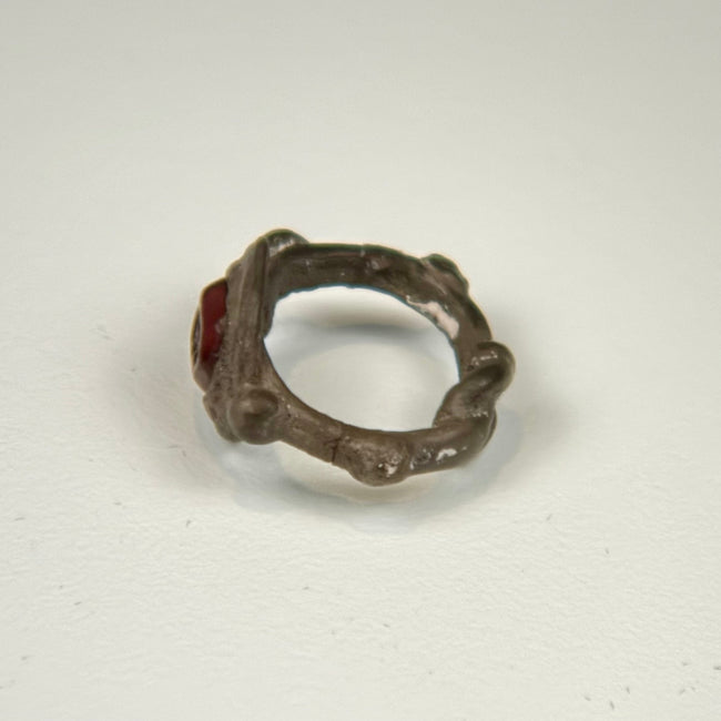Ancient silver garnet ring showing the sculptural bezel and symmetrical decorative elements along the shoulders