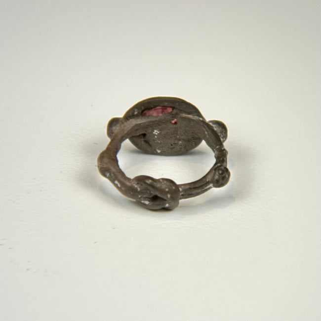 Ancient silver intaglio ring showing the circular band, aged patina, and elevated garnet bezel