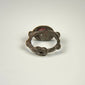 Ancient silver intaglio ring showing the circular band, aged patina, and elevated garnet bezel