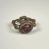 Ancient silver signet ring featuring an engraved red garnet intaglio and ornamental side nodes