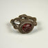 Late Roman silver ring with deep red garnet intaglio and decorative raised bezel, circa 300–600 CE