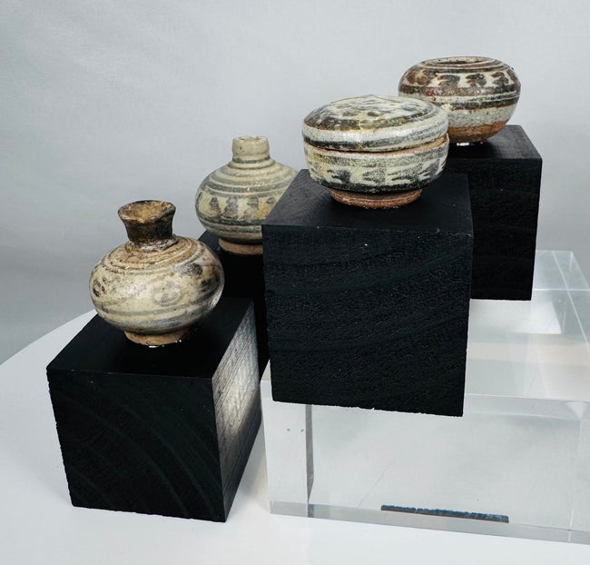 Group of four medieval Thai ceramic containers representing the export traditions of the Sawankhalok kiln region.