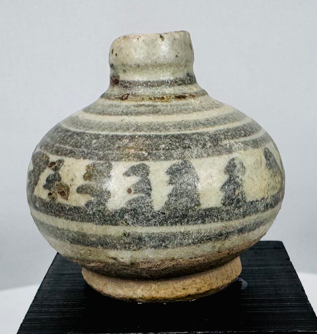 Medieval Thai glazed stoneware vessels with hand-painted geometric and floral designs characteristic of Sawankhalok ceramic production.