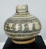 Medieval Thai glazed stoneware vessels with hand-painted geometric and floral designs characteristic of Sawankhalok ceramic production.