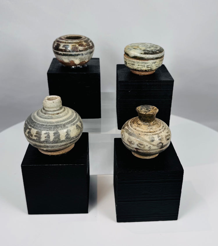 Ancient Thai Sawankhalok ceramic vessels with iron-black painted motifs beneath a transparent glaze, dating to the 14th–15th century CE.