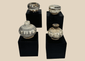 Group of four miniature Sawankhalok glazed stoneware vessels from Thailand's Sukhothai Period, featuring underglaze painted decoration and custom display stands.