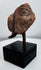Ancient Americas ceramic fragment depicting a stylized human face with large ear ornament