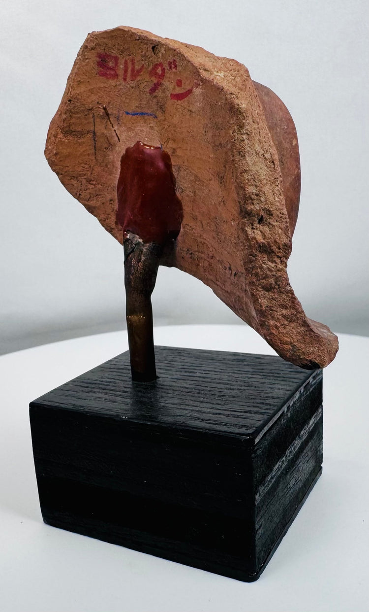 Ancient figural ceramic fragment mounted on display stand, retaining painted decoration and burial patina