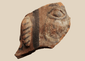 Ancient terracotta figural fragment with stylized eye and painted ear ornament, possibly Mesoamerican, circa 200 BCE–900 CE