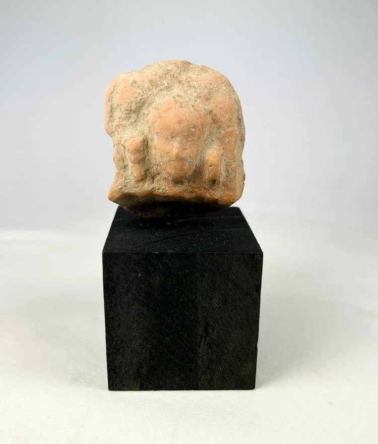 Gandharan terracotta fragment featuring central male figure and side figures