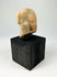 Gandharan terracotta fragment with central male figure and faint side images