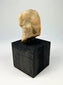 Gandharan terracotta fragment with central male figure and faint side images