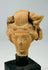 Detailed view of Mediterranean terracotta head fragment emphasizing sculptural artistry and fine facial modelled features.