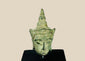 Small antique Southeast Asian bronze Buddha head, likely from Thailand or Cambodia, 16th–17th Century CE. Features serene expression, elongated earlobes, pointed ushnisha, and natural green patina. Originally part of a larger statue, serving as a devotional object reflecting Buddhist spiritual symbolism, artistry, and enlightenment.