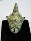 Early Southeast Asian Buddhist devotional sculpture with serene Buddha face and aged green bronze surface