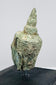Historic bronze Buddha head with peaceful facial features, elongated ears, and centuries-old verdigris patina