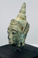Southeast Asian Buddhist bronze artifact with serene expression, green patina, and symbolic ushnisha