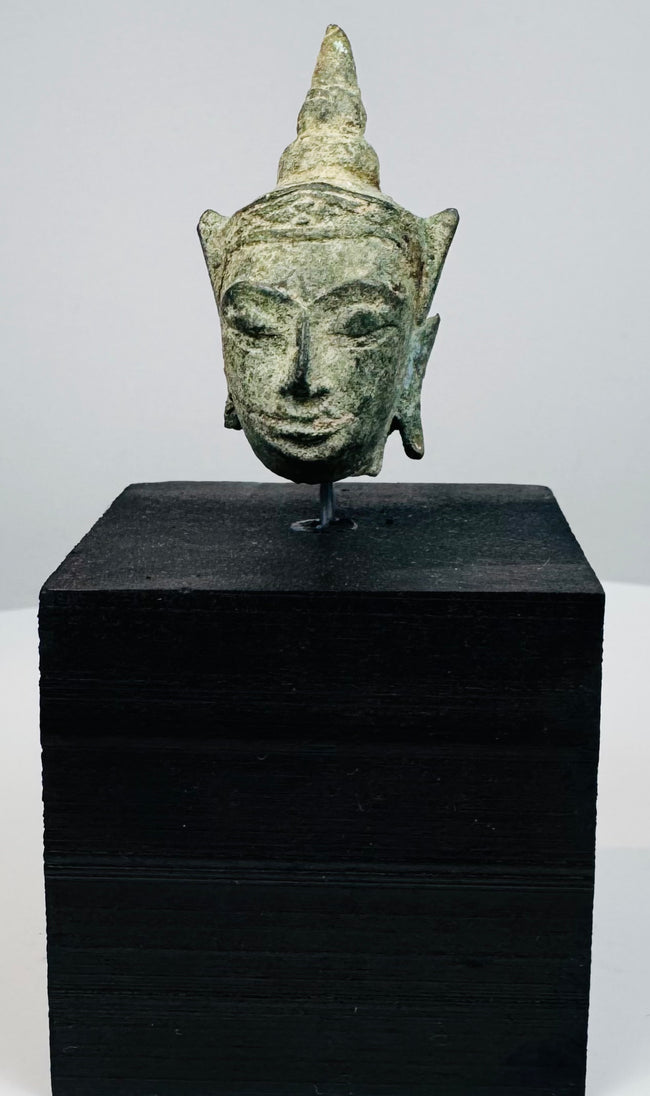 Antique Thai or Cambodian Buddha head sculpture with elongated earlobes and aged bronze surface