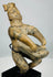 Close-up of ancient Pre-Columbian terracotta figure with earthen deposits