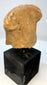 Pre-Columbian ceramic head with detailed braided hair and facial features