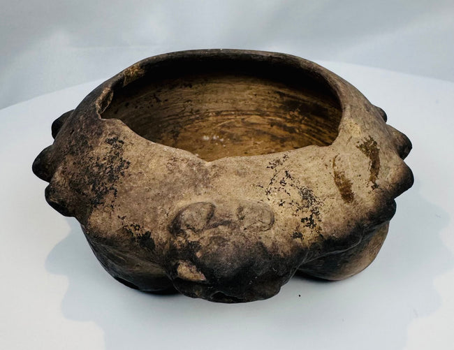 Ancient Colima, Jalisco, or Nayarit tripod ceramic bowl featuring hollow legs and sculpted animal heads around the rim.