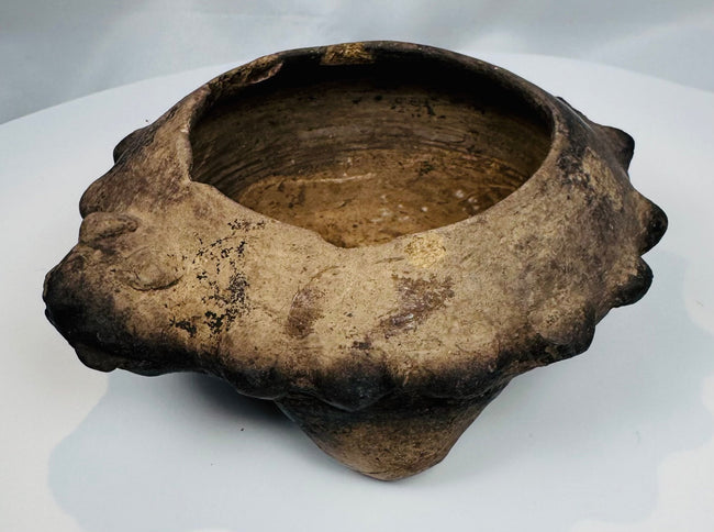Rare ancient West Mexican ceramic tripod bowl displaying three hollow supports and stylized zoomorphic head decoration.