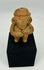 Ancient Mesoamerican terracotta figure with ritual seated pose and subtle traces of original pigment