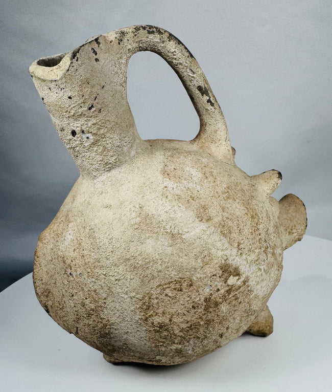 Ancient Yortan pig-shaped pottery vessel with projecting snout, tripod feet, and stirrup handle.