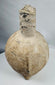 Close-up of the Yortan Culture pig-shaped vessel showing the arched handle, spout, and weathered ancient surface.