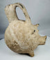 Ancient Anatolian Yortan Culture ceramic pig vessel featuring traces of white slip and archaeological patina.