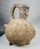 Hand-modeled terracotta zoomorphic vessel in the form of a pig from the Yortan Culture of ancient Anatolia.