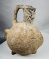 Hand-modeled terracotta zoomorphic vessel in the form of a pig from the Yortan Culture of ancient Anatolia.