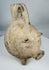 Authentic Yortan Culture pig-form ceramic vessel displaying mineral deposits and burial encrustation.