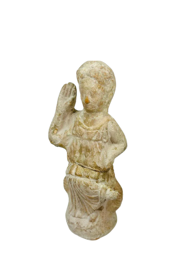 Ancient carved stone female figurine seated with raised hand gesture wearing draped garment