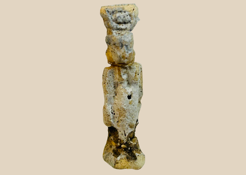 Ancient Egyptian faience amulet figure with heavy burial patina shown upright.
