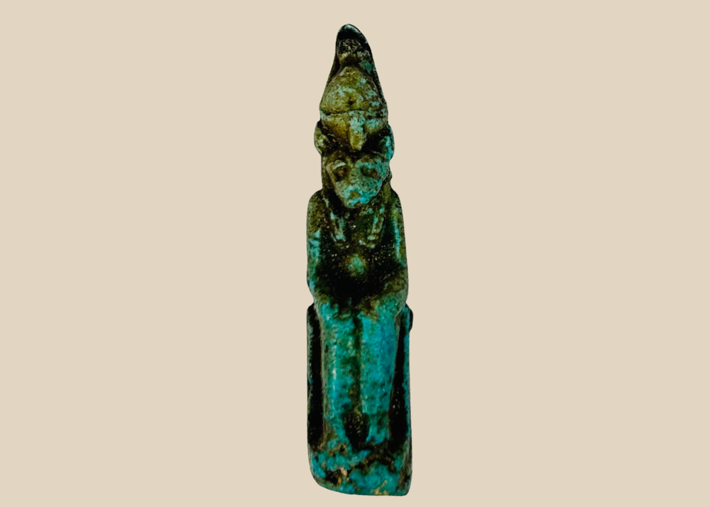 Ancient Egyptian seated Sekhmet amulet carved in stone, front view.