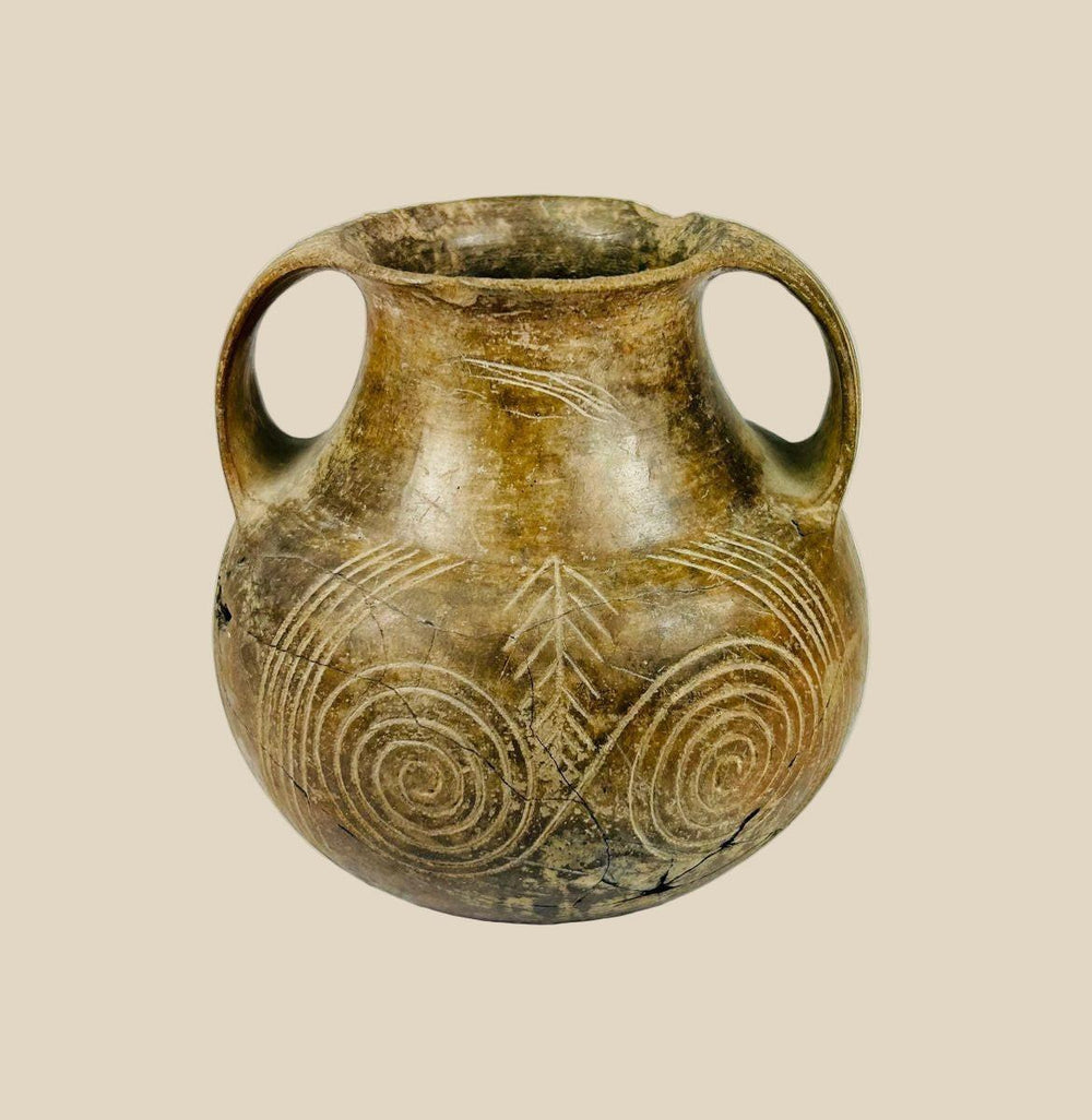Neolithic to Early Bronze Age terracotta jug from Central or Eastern Europe, circa 3000–2000 BCE. Handmade pottery with incised geometric motifs and double handles, used for ceremonial offerings or daily storage. Reflects early European craftsmanship, symbolic artistry, and ancient ritual practices.