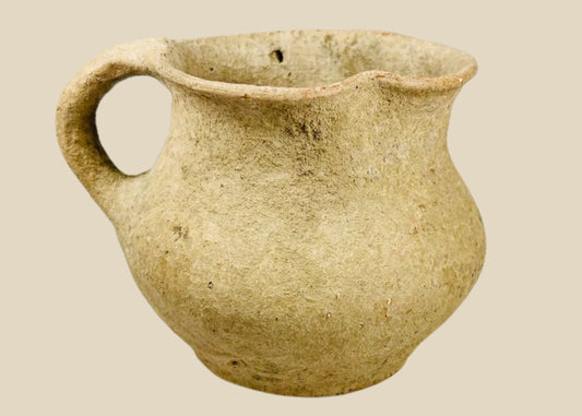 Ancient Greco-Roman terracotta pitcher, 1st–3rd century CE, with single rounded handle, wide mouth, and aged earthen surface.