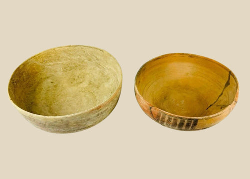 Two ancient Indus Valley terracotta bowls, circa 2nd–3rd millennium BCE; one plain with natural earthen patina, the other decorated with geometric polychrome painted motifs, both exhibiting age wear and archaeological restoration.