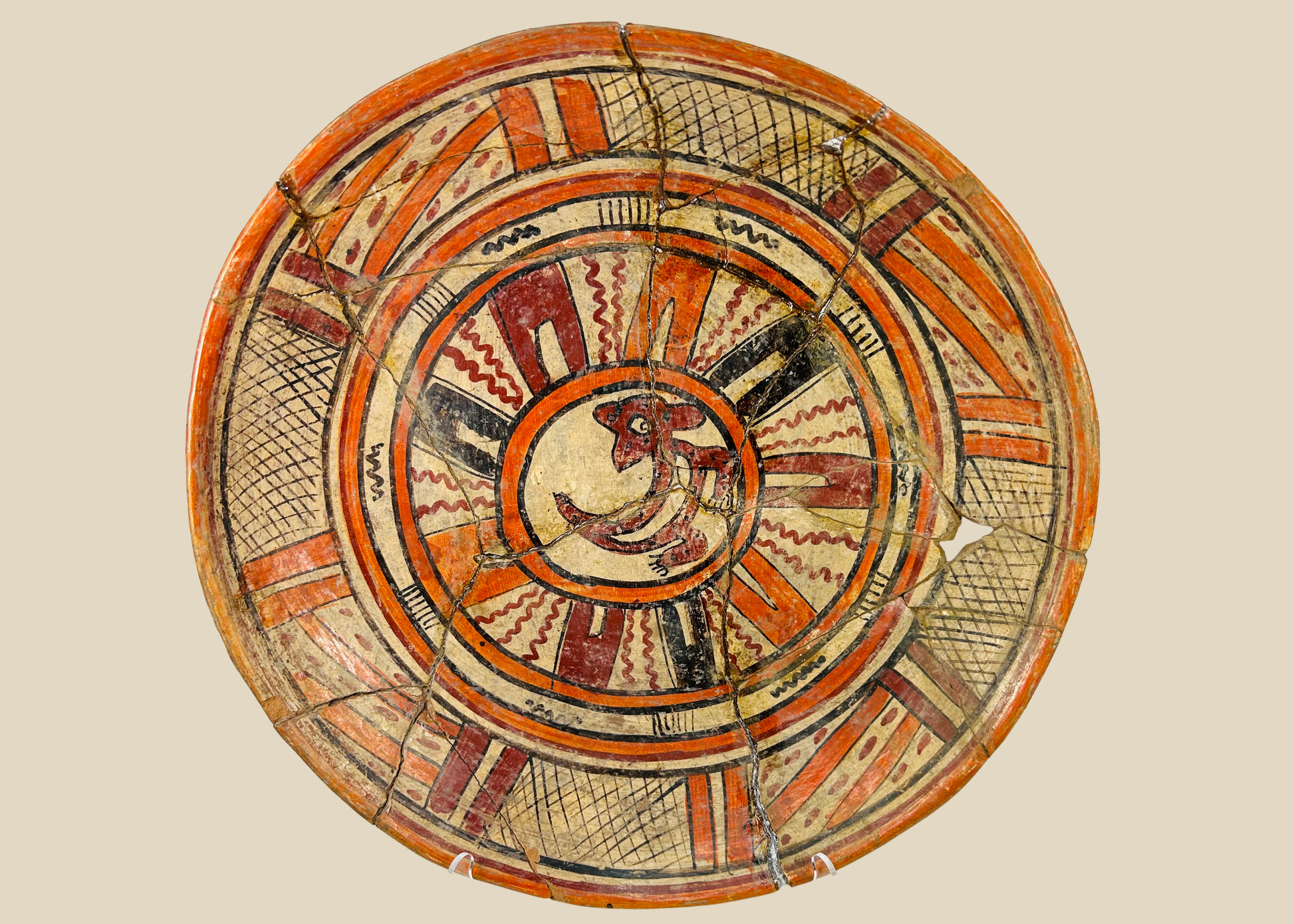 Ancient Mesoamerican polychrome ritual plate with vivid zoomorphic motif and geometric border, circa 300 BCE–300 CE.