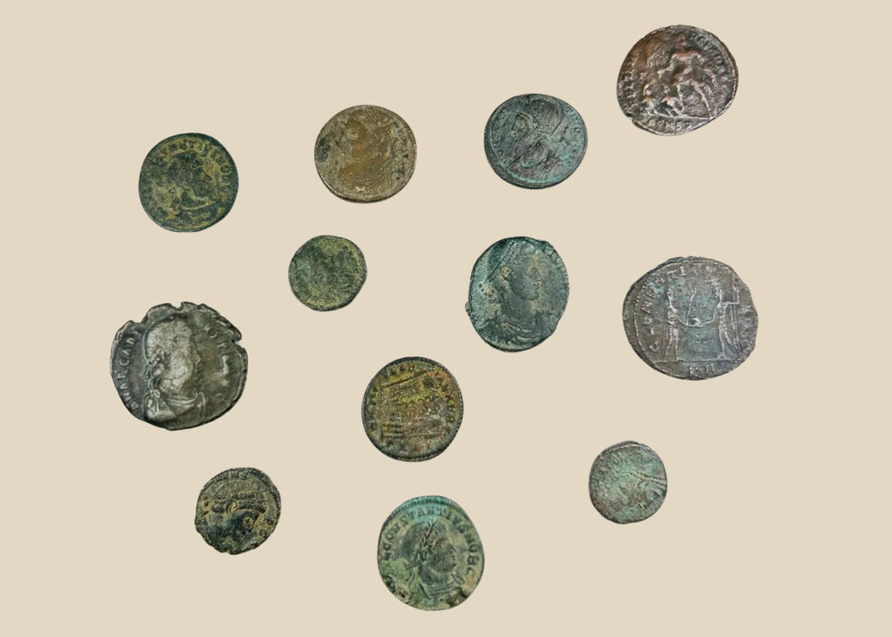 Collection of 12 ancient Roman bronze coins, varying in size and condition, featuring worn imperial busts and reverse imagery; authentic hoard of currency from the Roman Empire with patinated surfaces and archaeological character.